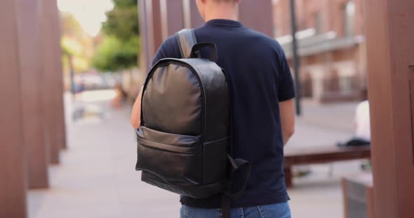 Rear View Man Walking in City with Black Leather Backpack