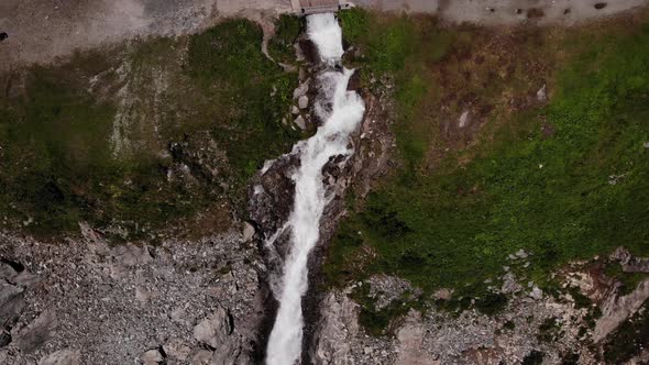 Bird's Eye View Of Waterfall Flowing By The Cliff In Austria. - aerial drone