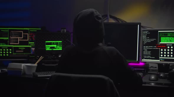 Hacker Girl in Dark Hood Attacks Servers in Dark Room