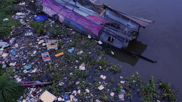 Aerial drone shot passing over A sunken and abandoned House boat in a Canal of Ho Chi Minh City Viet