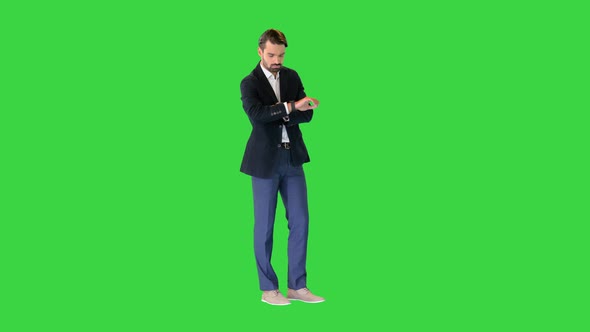 Businessman Using Digital Watch While Standing on a Green Screen Chroma Key