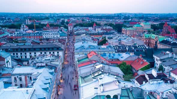 Poland Krakow rooftop timelapse at subset red roof tiles street lights birds eye view houses from to