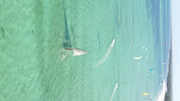 Vertical Video Kitesurfing Near the Shore of Zanzibar Tanzania Aerial View