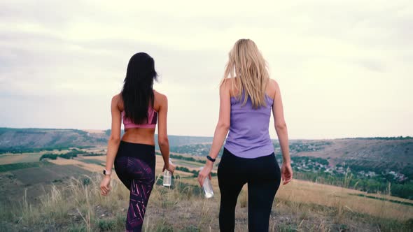 Two Woman Drinking Water After Sports