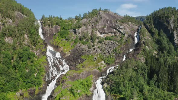 Drone Rising Up Mountainside With Cascading Water