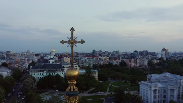 Golden Church Cross with View on the City