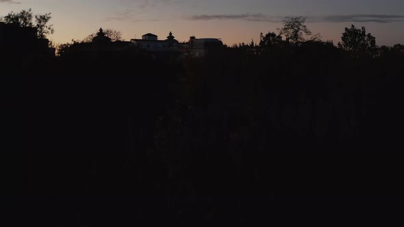 Ascending Footage of Trees in Park Silhouettes Against Colour Sunset Sky