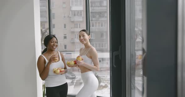 Young Women Eating Fresh Apple After Training