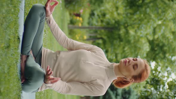Vertical Screen Young woman doing yoga in nature