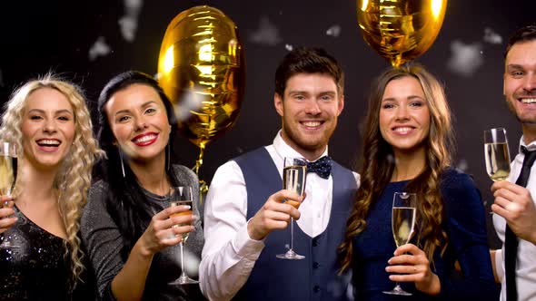 Happy Friends with Champagne Glasses at Party