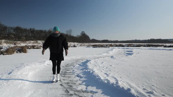 Lonely young female is skating outdoors