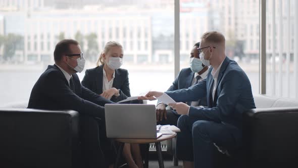 Diverse Business Team in Protective Masks Working in Modern Office