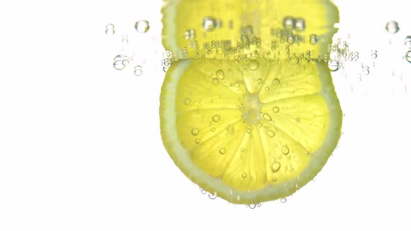 The Concept of Freshness a Slice of Lemon in Clear Water with Refreshing Gas Bubbles Closeup