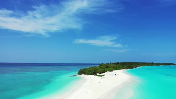 Aerial drone landscape of tropical coastline beach vacation by shallow ocean and white sand backgrou