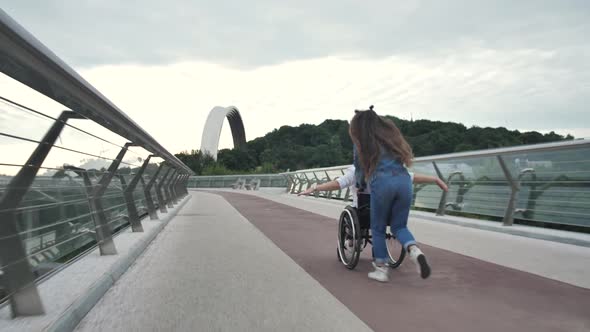 Girl with Disabled Mom Enjoying Ride on Wheelchair