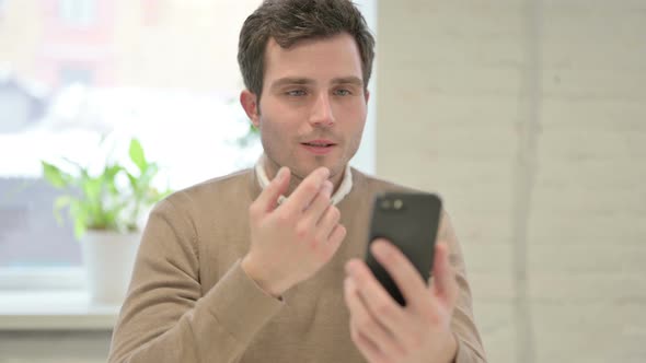 Man Talking Video Call on Smartphone in Office
