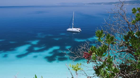 Top Video of a White Boat Sailing in the Blue Turquoise Water. Summer Holidays on Water. Vacation