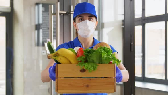 Delivery Woman in Face Mask with Food in Box