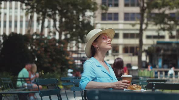 Smiling woman at the table in park