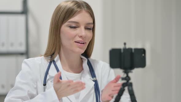 Female Doctor Recording Video on Smartphone