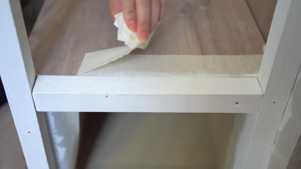 Crop unrecognizable woman sticking duct tape on steps at home