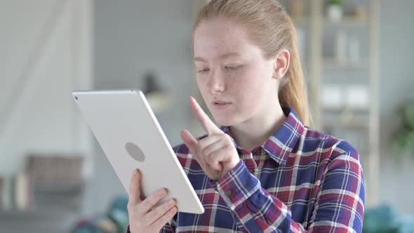 Young Woman Shopping Online Using Tablet