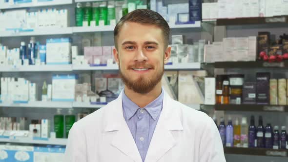 Young Pharmacist Showing Medication and Smiling