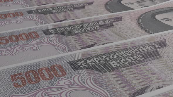 5000 North Korean won bills background. Many banknotes.