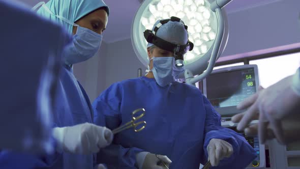 Low angle view of Middle-east female surgeon performing surgery in operation theater at hospital