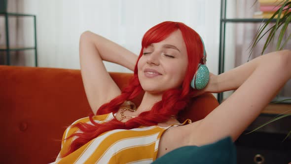 Girl in Wireless Headphones Listening Favorite Disco Music Relaxing Sleeping Resting at Home Couch