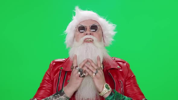 Freaky Santa Claus on a Green Background Funny Santa Arranges a Performance Chroma Key Template