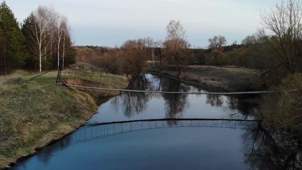 Old Handmade Bridge Wooden in Forest To Cross River. Small Nice Bridgework. Aerial View