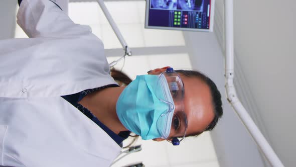 Vertical Video Doctor Measuring Woman Temperature Before Dental Examination