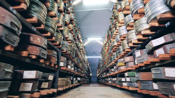 Passage Between the Shelves with Film Reels in Cases