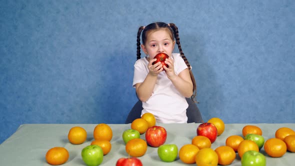 Pretty little girl eating tasty apple