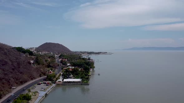 Aerial drone footage of a lakeside road along Lake Chapala, Mexicos largest freshwater lake