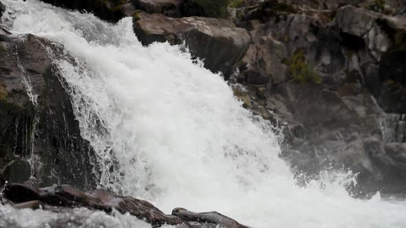 A slow motion shot of a roaring waterfall.