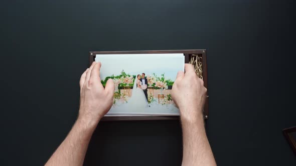 the Photographer Puts Wedding Photos and a Flash Drive in a Box