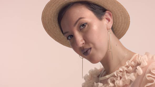 a Young Moroccan Woman Wears a Hat in the Studio and Monochrome Makeup