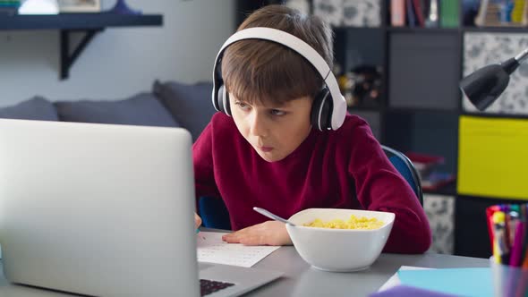 Video of boy doing homework during homeschooling. Shot with RED helium camera in 8K