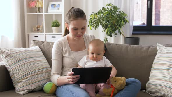 Mother with Baby and Tablet Pc at Home