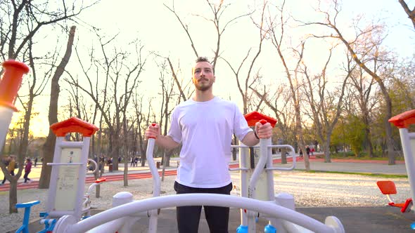 Man doing fitness with sports equipment in the park.