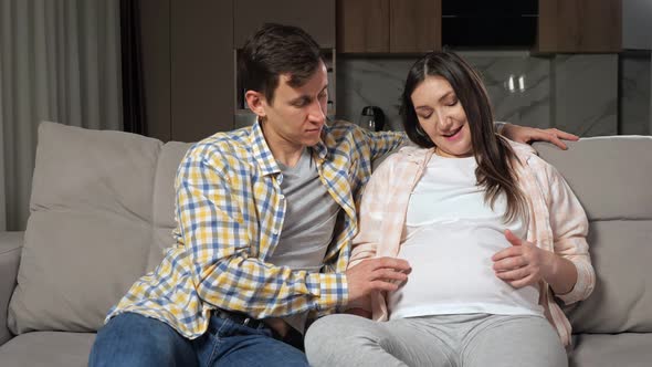 Young Woman and Man Caress Playing with Pregnant Large Belly