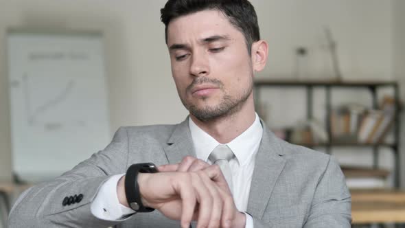 Businessman Using Smartwatch in Office