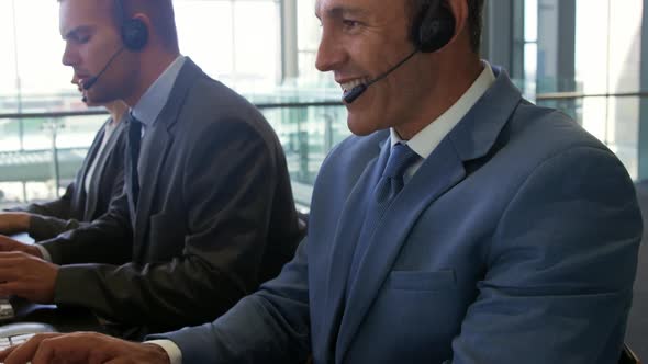 Business people wearing headsets in a modern office