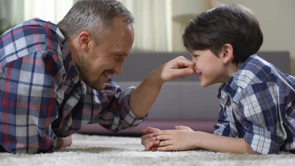 Male Family Playing on the Floor at Home, Having Fun Together, Weekend Leisure