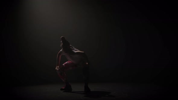 Teenager in Casual Clothers Dance Improvising in Black Studio. King Making Up Movements. Creative