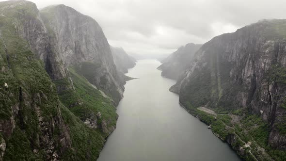 Drone Over Misty River Valley With Cliffs