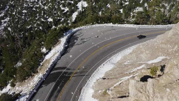 Black Car Driving on Mountain Top Road in Snowy Landscape, Aerial View