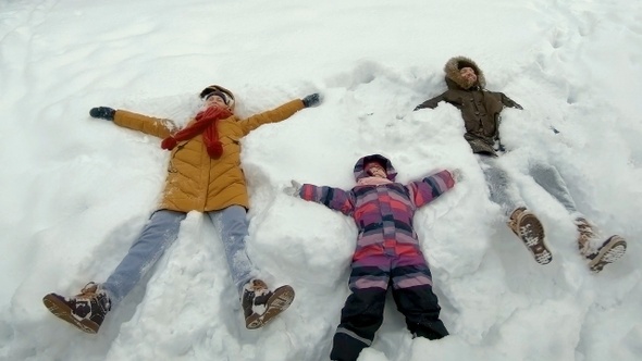 Family lying in snow